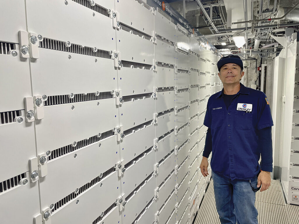 Engineer Peter DeMaria stands alongside Corvus lithium-ion battery banks below deck in eWolf’s mechanical space.